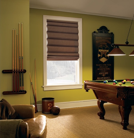 Roman shades in Orlando game room with green walls.